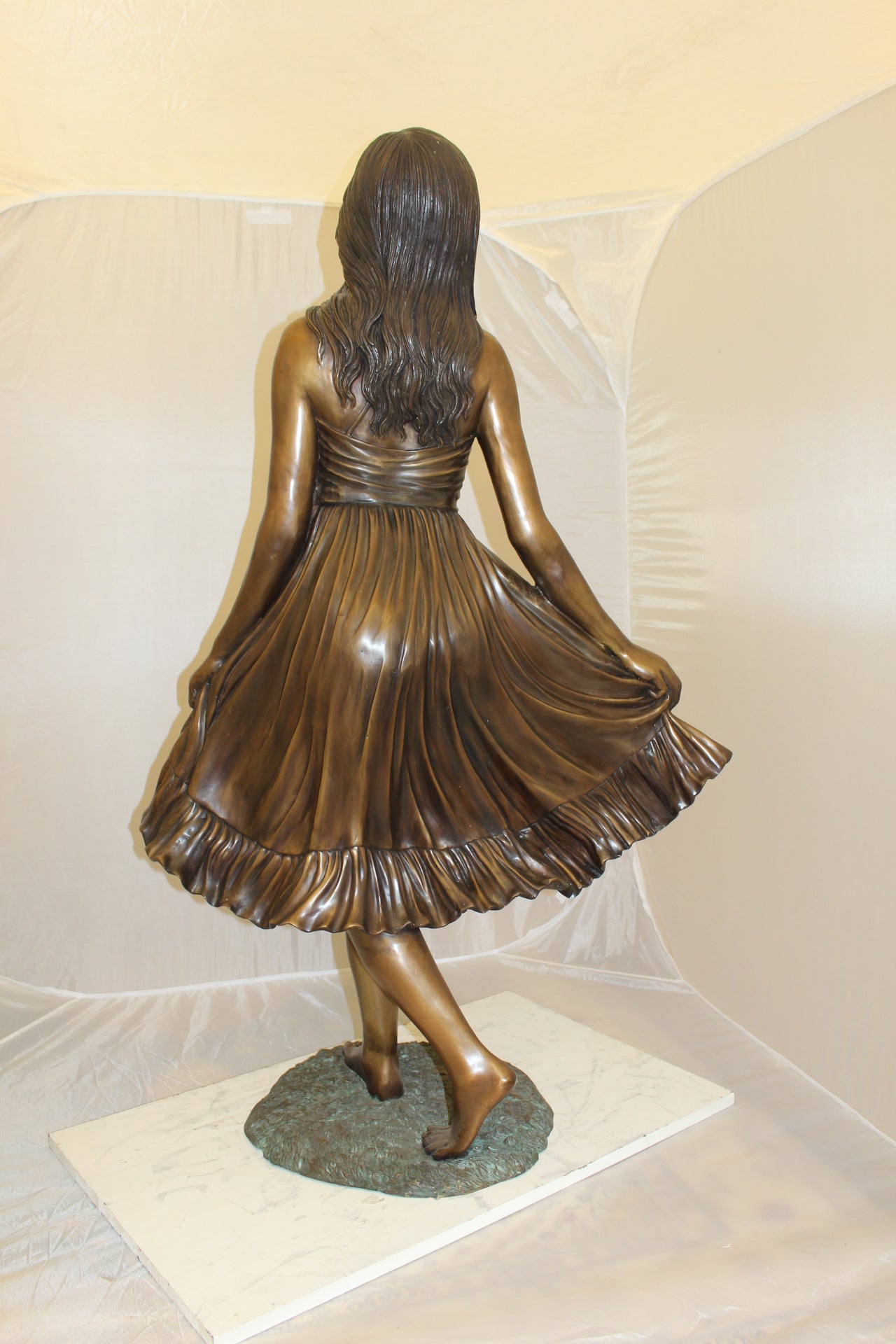 Lady holding her Skirt Bronze Statue -  Size: 32"L x 17"W x 53"H. 