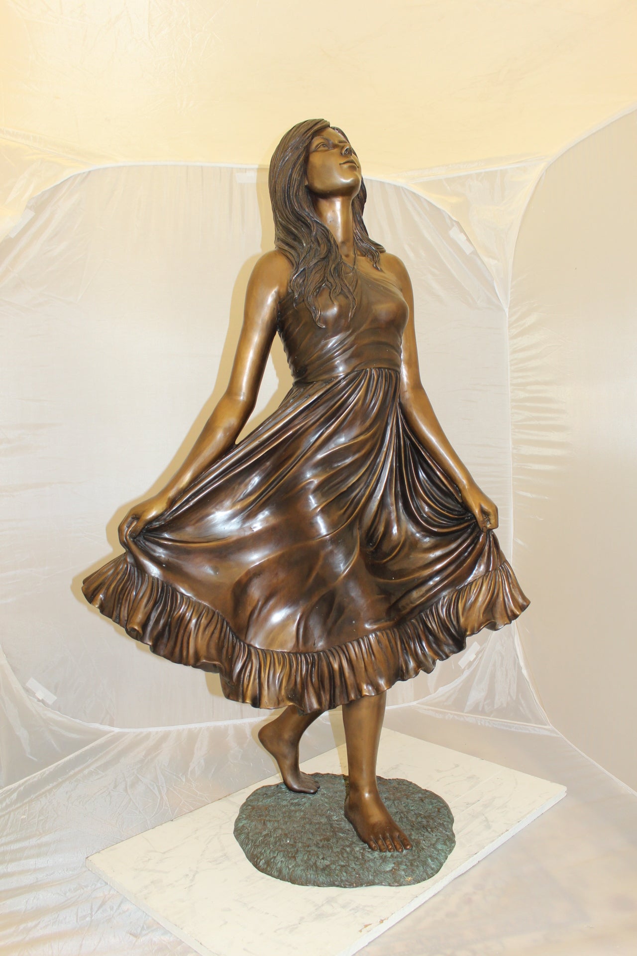 Lady holding her Skirt Bronze Statue -  Size: 32"L x 17"W x 53"H. 