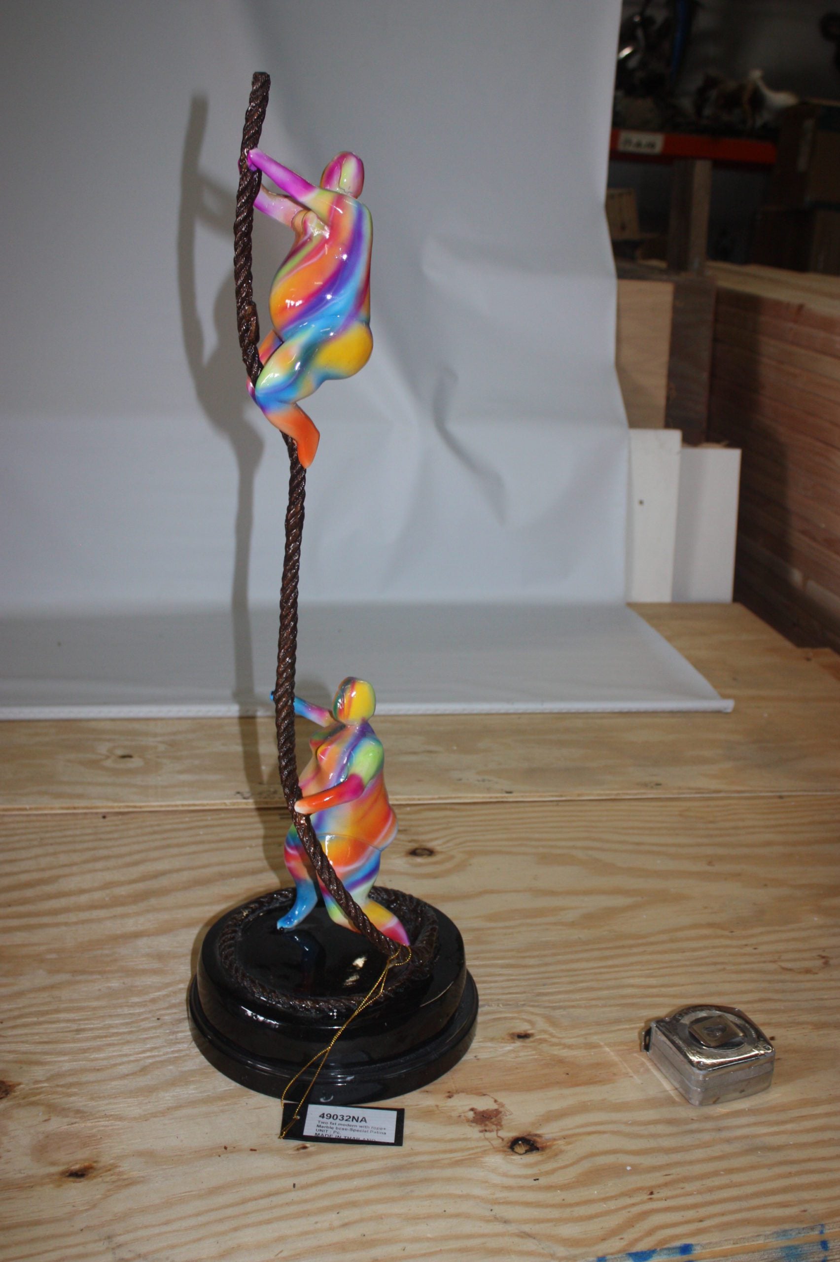 Two fat ladies made of Bronze climbing on rope -  Size: 10"L x 10"W x 31"H. 