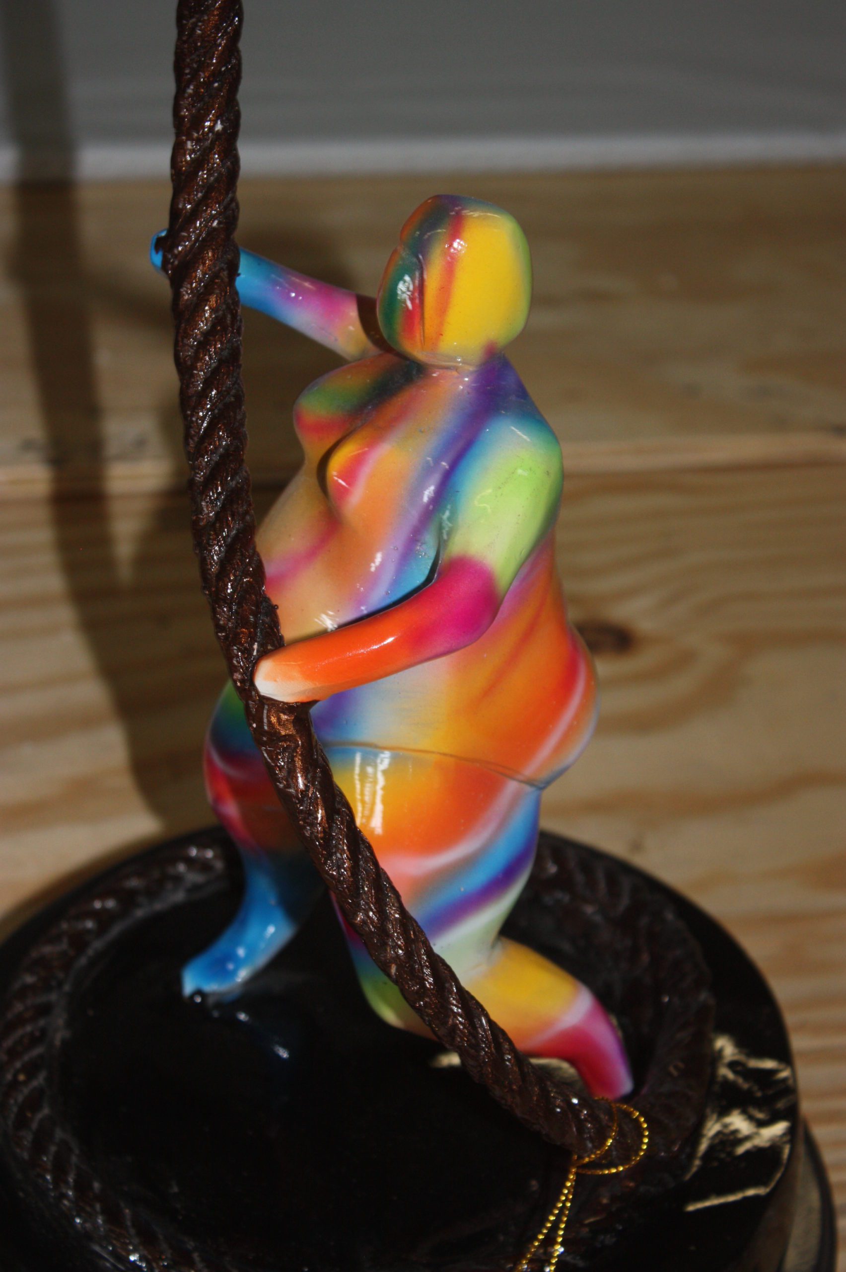 Two fat ladies made of Bronze climbing on rope -  Size: 10"L x 10"W x 31"H. 