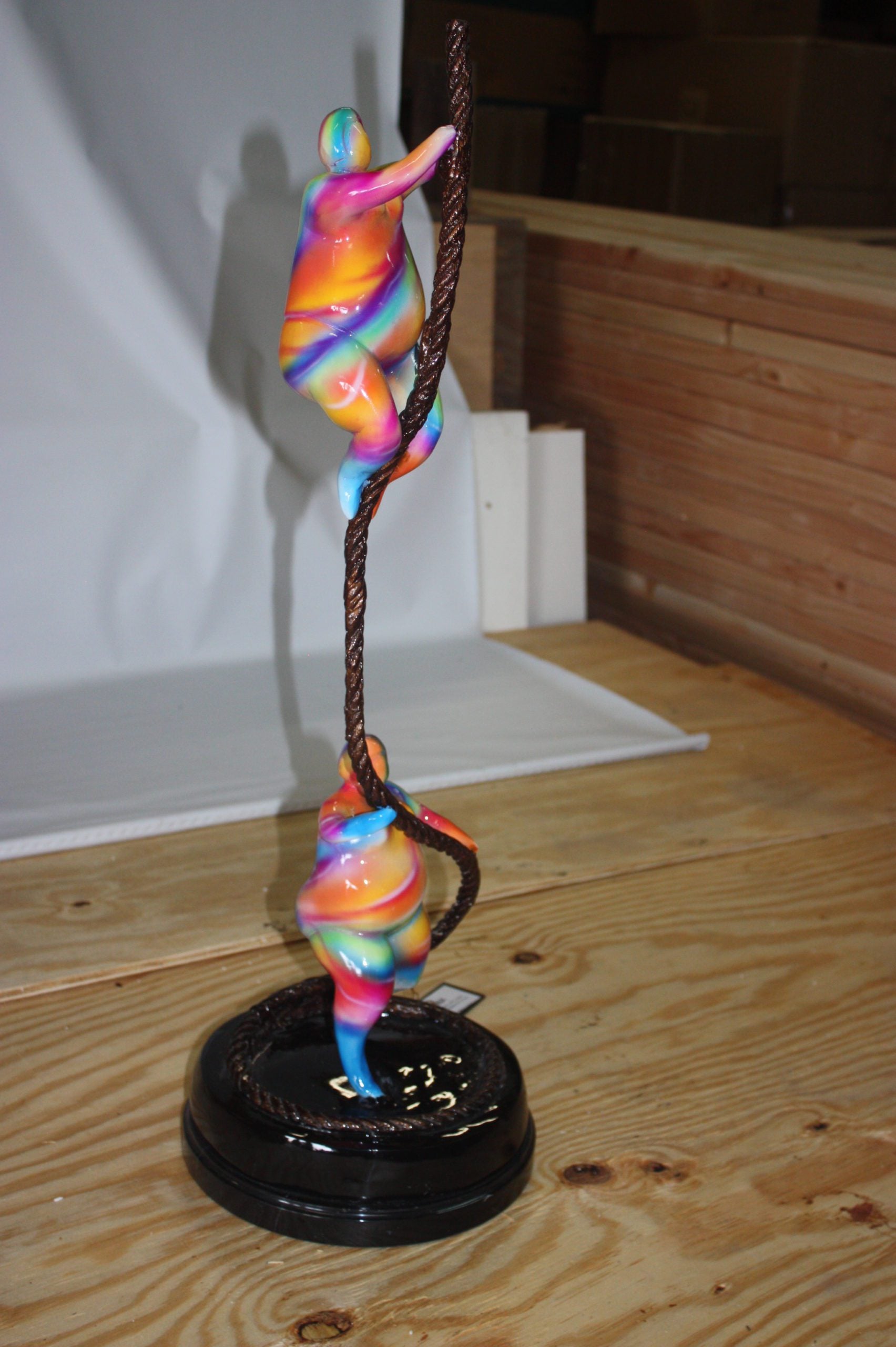 Two fat ladies made of Bronze climbing on rope -  Size: 10"L x 10"W x 31"H. 