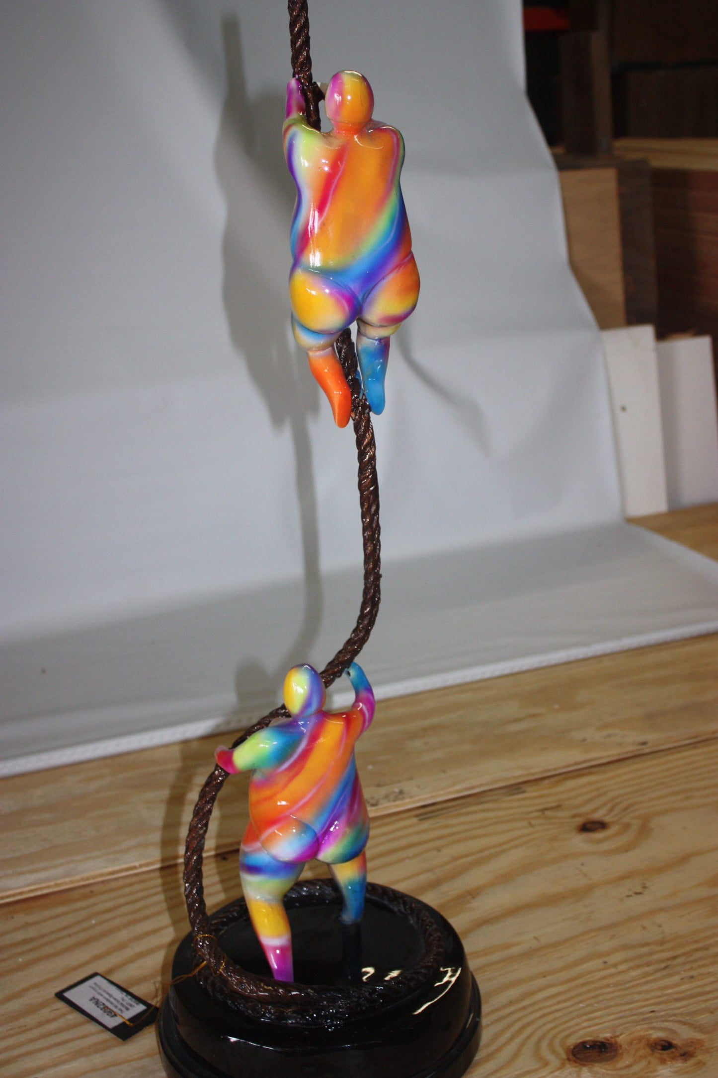 Two fat ladies made of Bronze climbing on rope -  Size: 10"L x 10"W x 31"H. 