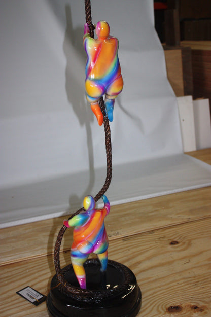 Two fat ladies made of Bronze climbing on rope -  Size: 10"L x 10"W x 31"H. 