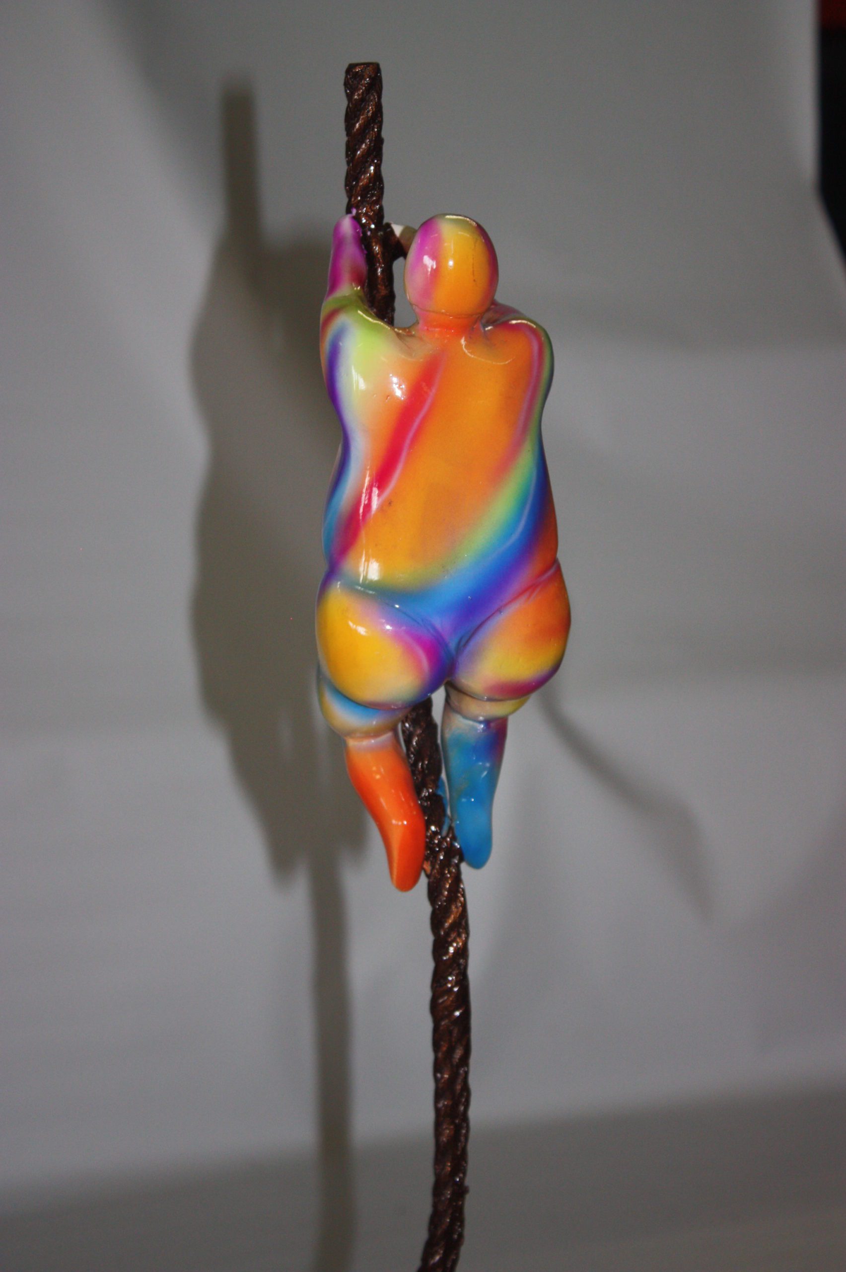 Two fat ladies made of Bronze climbing on rope -  Size: 10"L x 10"W x 31"H. 