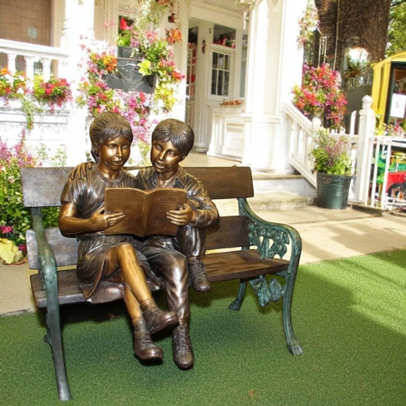Kids Reading a Book on a Bench Bronze Statue -  Size: 23"L x 38"W x 37"H.