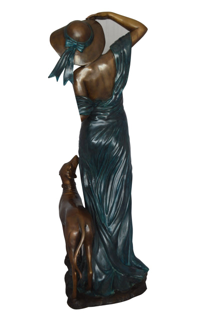 Lady With Her Dog Bronze Statue -  Size: 25"L x 22"W x 50"H. 