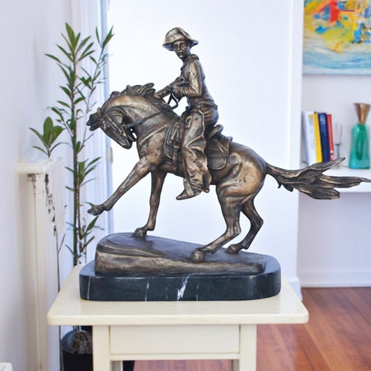 Remington replica Cowboy bronze statue -  Size: 5"L x 15"W x 13"H.