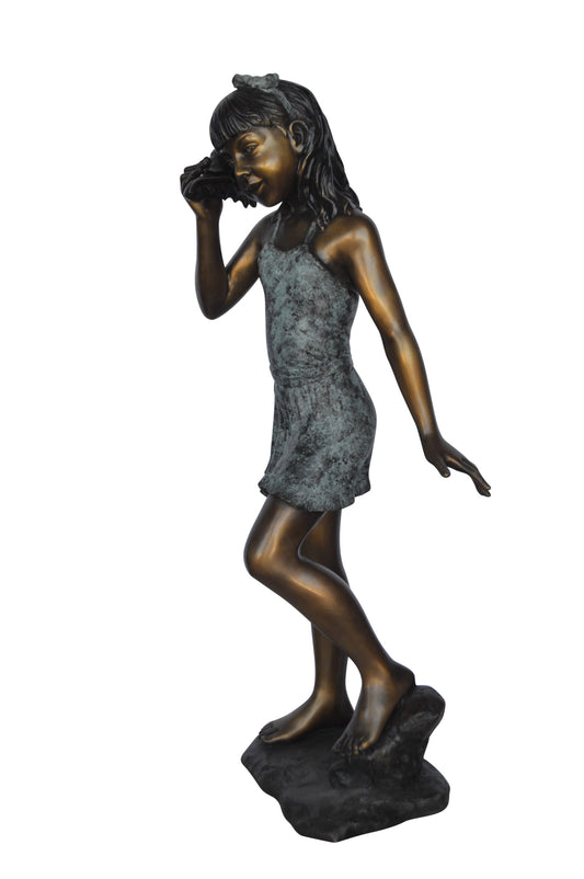 Standing Girl Listening to a Shell Bronze Statue -  Size: 16"L x 12"W x 37"H.