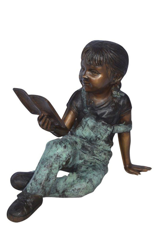 Young girl laying and reading book bronze statue -  Size: 18"L x 9"W x 16"H.