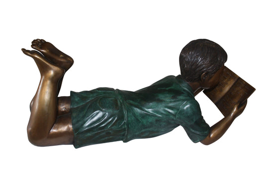 boy laying reading book bronze Statue -  Size: 24"L x 10"W x 11"H. 