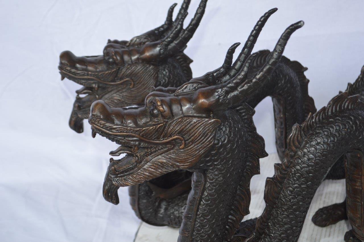 Pair of Dragons sitting side by side bronze statues -  Size: 31"L x 7"W x 16"H.