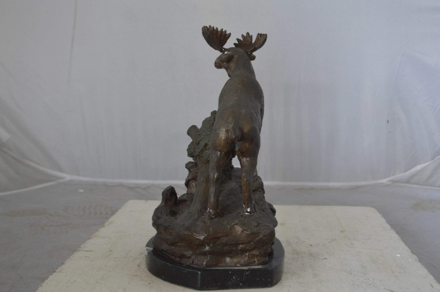 Moose on a rock bronze statue - Size: 9"L x 7"W x 14"H.