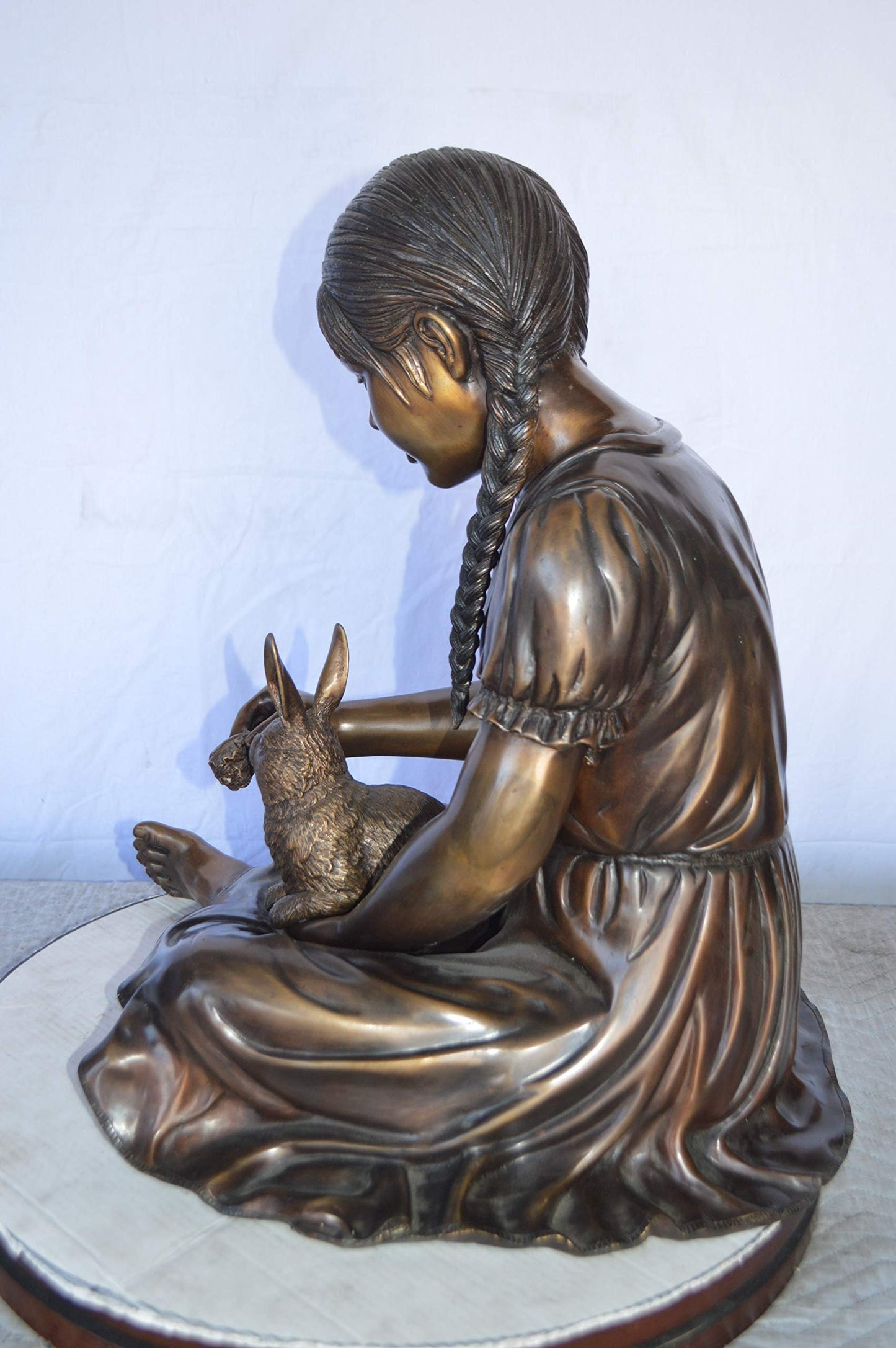Sandra Sitting With Her Rabbit Bronze Statue -  Size: 25"L x 18"W x 25"H.