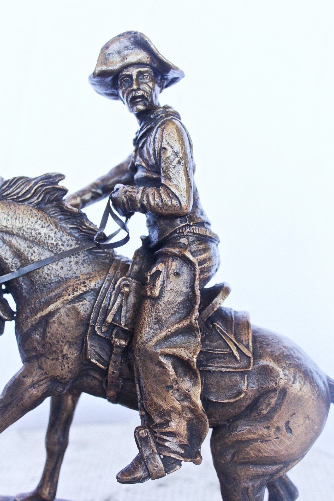 Remington replica Cowboy bronze statue -  Size: 5"L x 15"W x 13"H.
