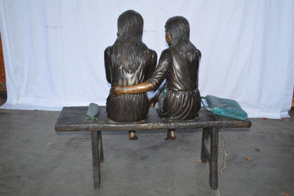 Two Schoolgirls Sitting On a Bench Bronze Statue -  Size: 45"L x 24"W x 41"H.