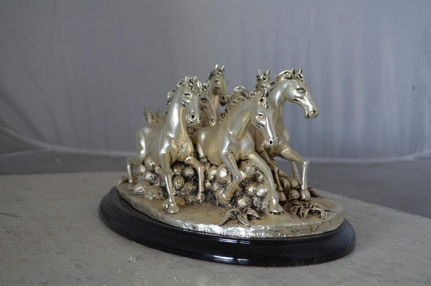 Charging horses resin statue on wood base - Size: 17"L x 10"W x 5"H.