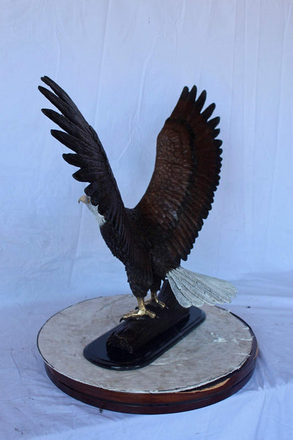 Perched eagle bronze statue -  Size: 35"L x 21"W x 29"H.