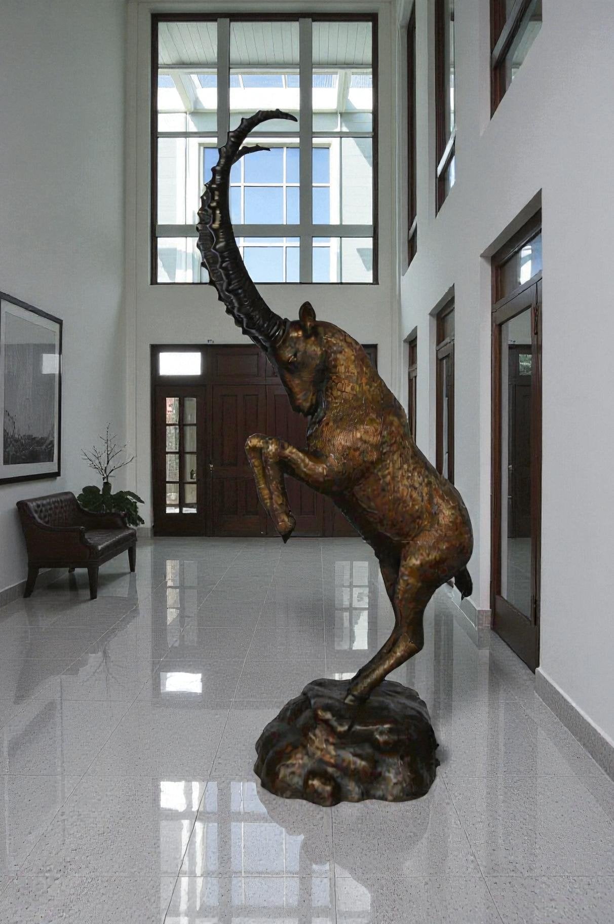 Mountain goat on hind legs bronze statue -  Size: 36"L x 16"W x 66"H.
