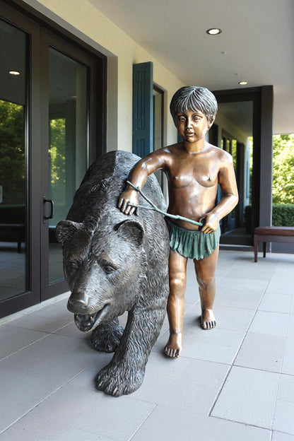 A bear with a boy bronze statue -  Size: 39"L x 24"W x 32"H.