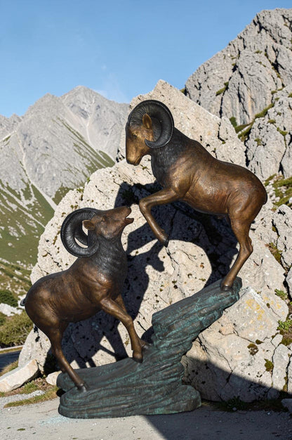 Two Life Size Rams on a rock Bronze Statue - Size: 49"L x 20"W x 64"H.