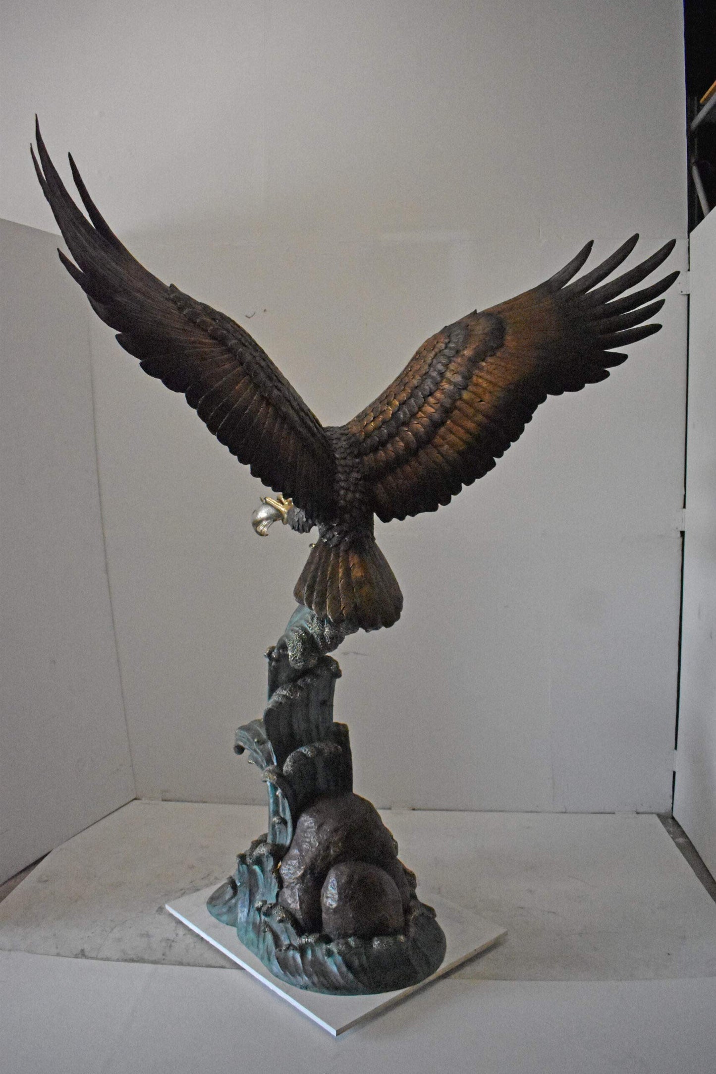 Eagle in Action Catching His Prey Bronze Statue - Size: 68"L x 40"W x 87"H.
