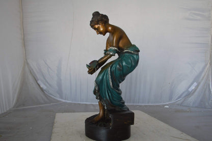 Lady holding a bird bronze statue - Size: 10"L x 9"W x 20"H.