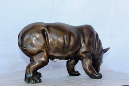 Relaxed Rhino bronze statue -  Size: 16"L x 9"W x 8"H.