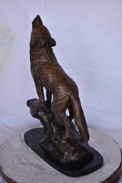 Howling Wolf at Edge of a Cliff Bronze Statue - Size: 9" L x 20" W x 26" H.