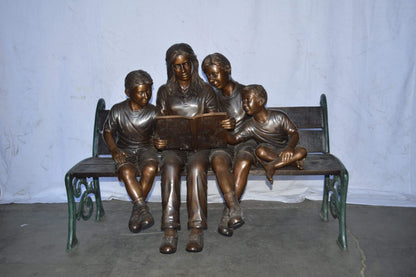 Mom and boys reading stories on bench bronze statue - Size: 53"L x 33"W x 39"H.