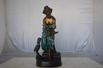 Lady holding a bird bronze statue - Size: 10"L x 9"W x 20"H.