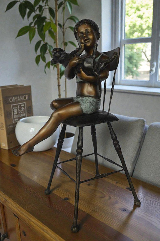 Girl with a cat on a high chair bronze statue -  Size: 16"L x 16"W x 38"H.