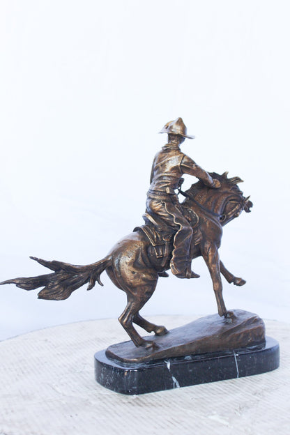 Remington replica Cowboy bronze statue -  Size: 5"L x 15"W x 13"H.