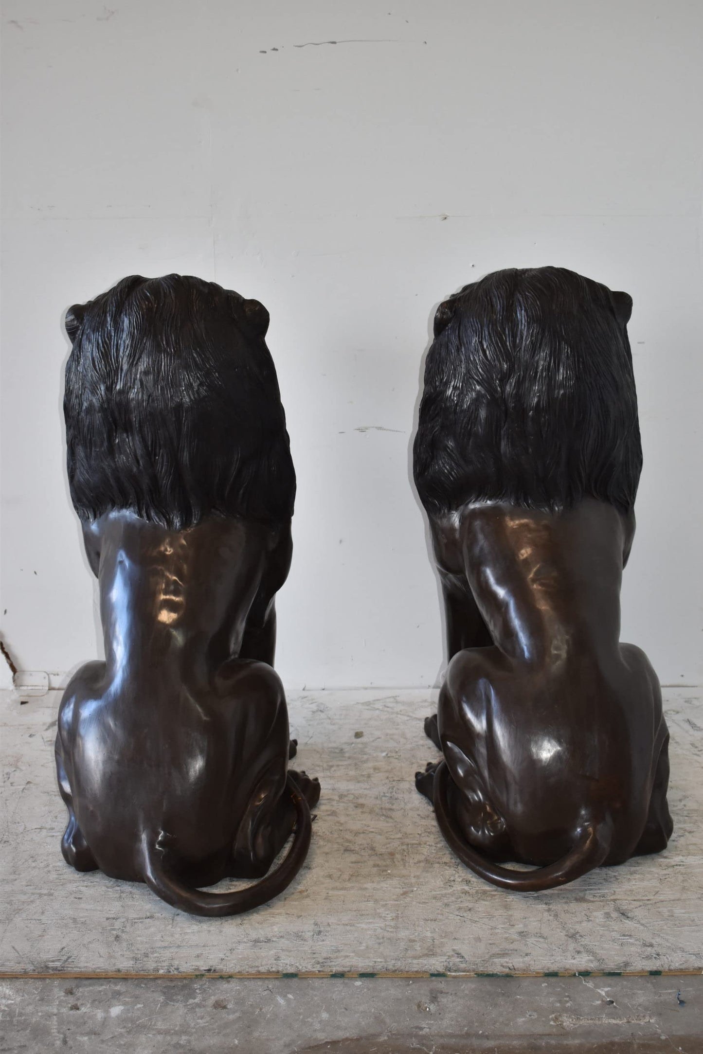 A Pair of Large Lions Sitting Side by Side Bronze Statues Size: 23" x 33" x 46"H