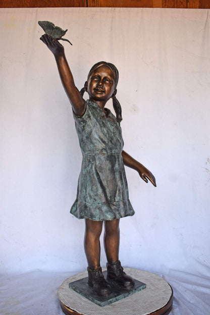 Young Girl Holding a Butterfly Outside at The Park - Size: 21"L x 11"W x 49"H