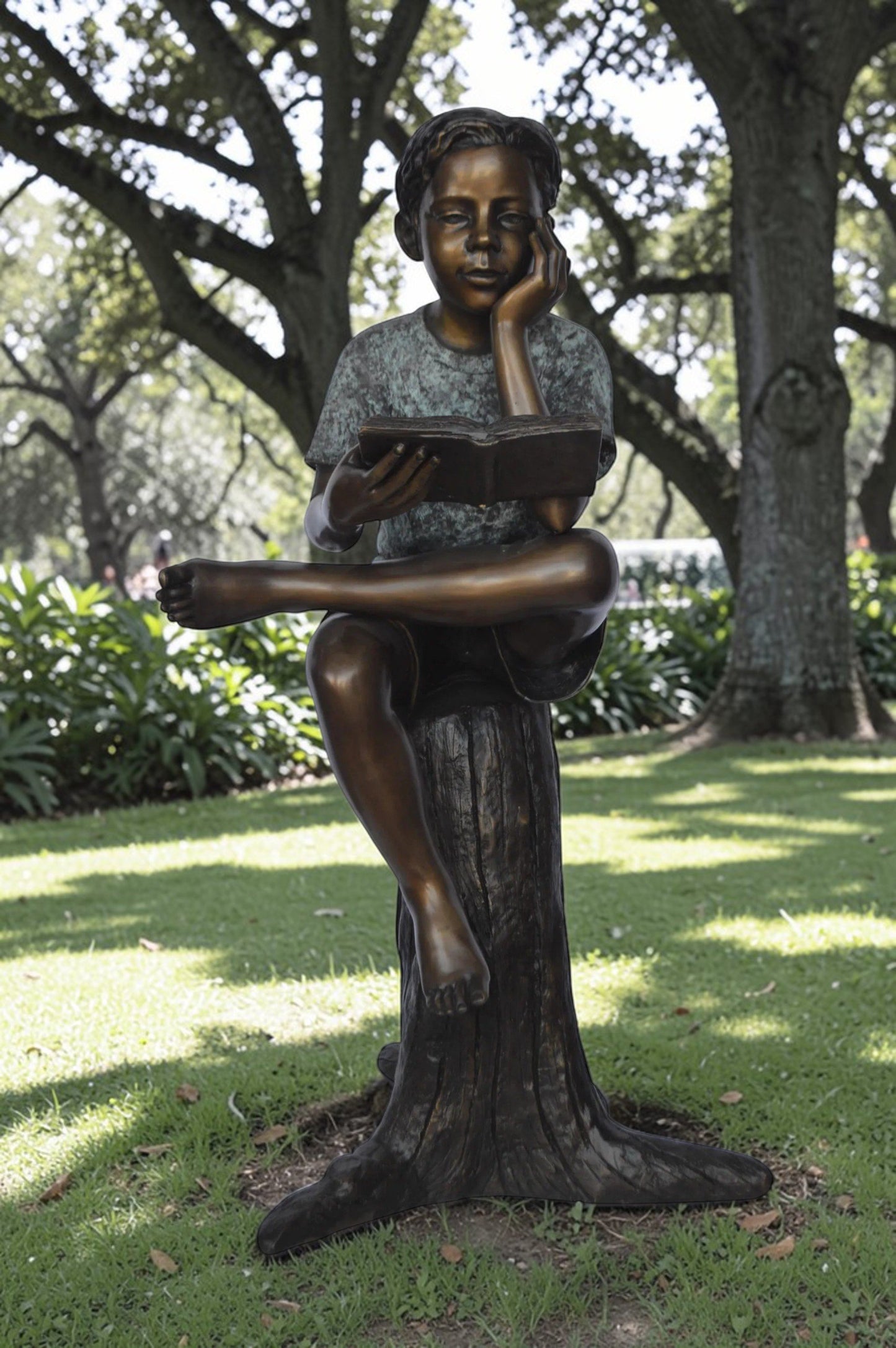 Boy Sitting on a Stump Reading a Book -  Size: 18"L x 20"W x 35"H.