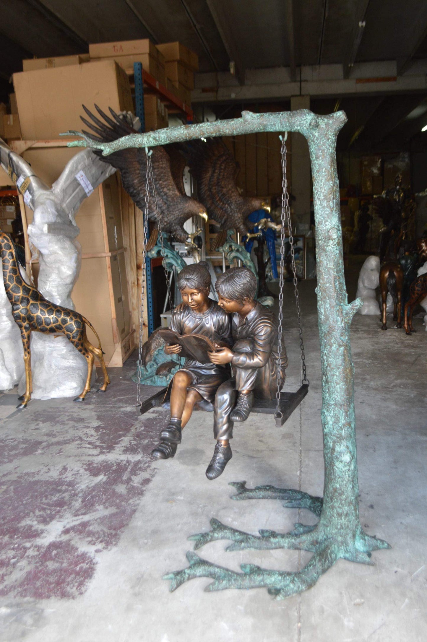 NIFAO Kids on Swing Set Reading a Book Bronze Statue – Rhian Handcrafted Sculpture with Joyful Detail for Gardens, Lawns, or Playful Outdoor Spaces – 50" L x 40" W x 70" H