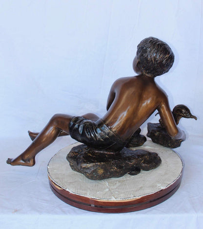 Adventurous boy with squirrel bronze statue -  Size: 36"L x 18"W x 22"H.