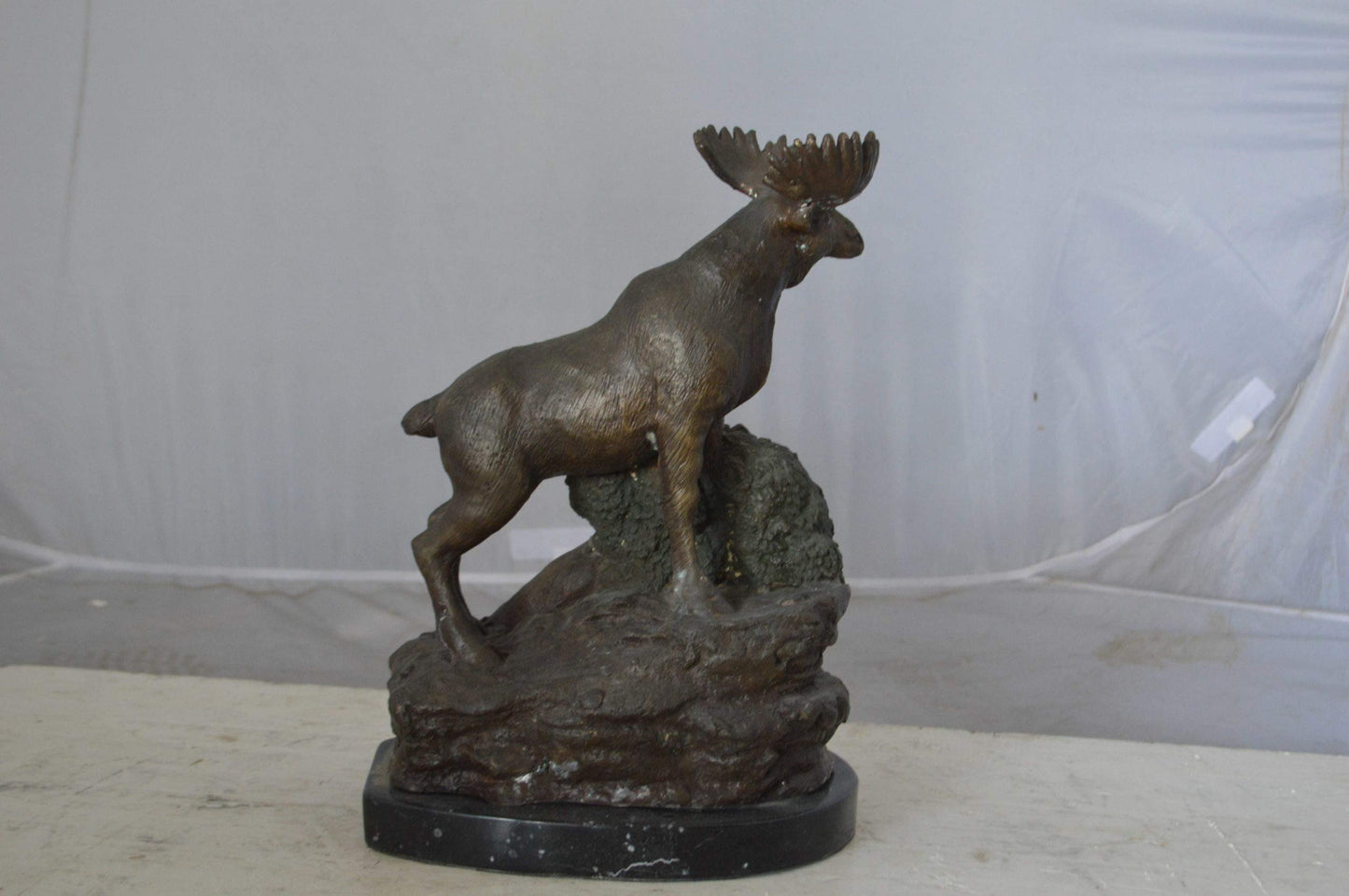 Moose on a rock bronze statue - Size: 9"L x 7"W x 14"H.