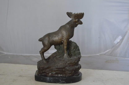 Moose on a rock bronze statue - Size: 9"L x 7"W x 14"H.