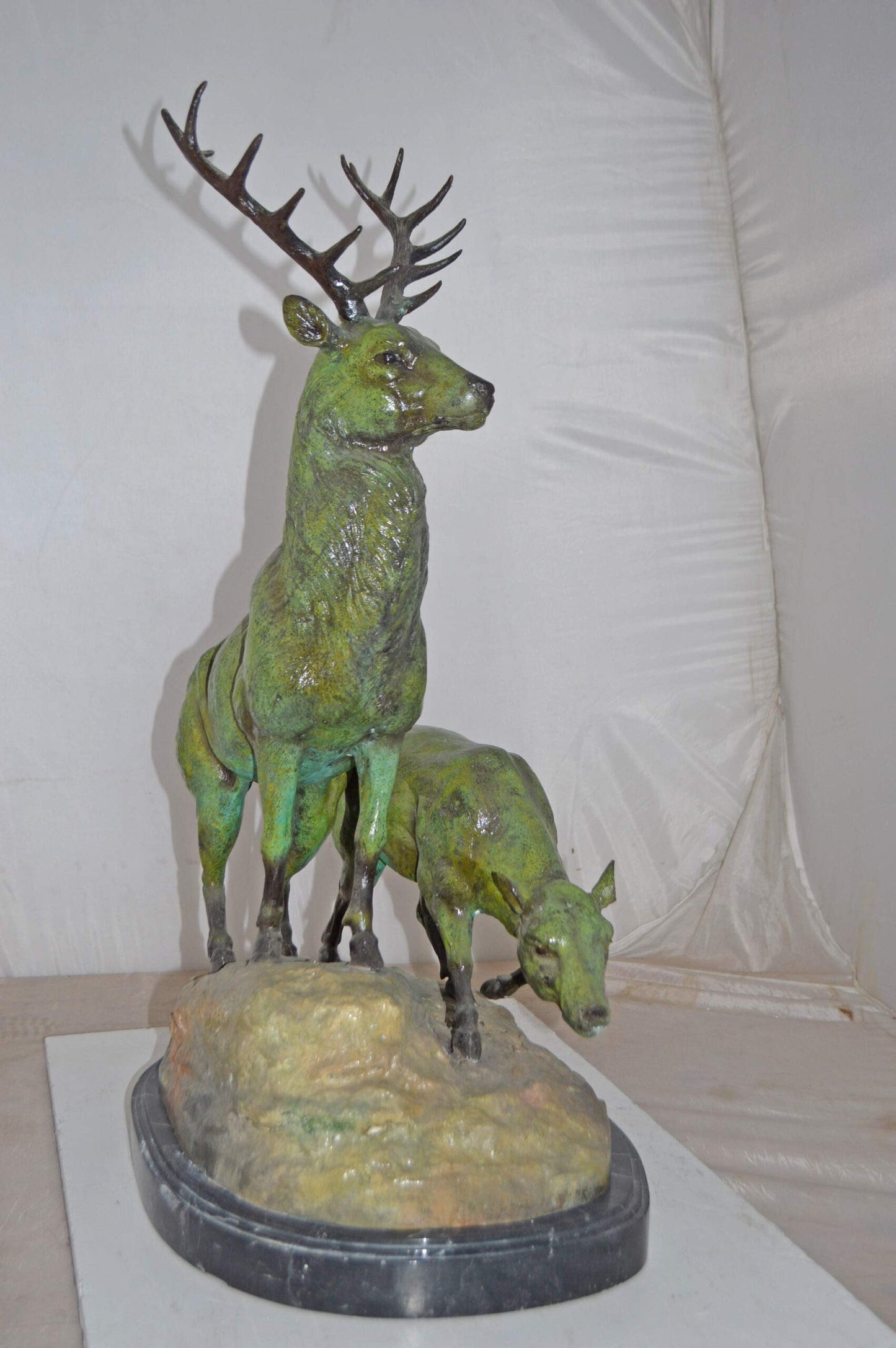 Two Deers Bronze Statue with a Green patina finish - Size: 15"L x 22"W x 32"H.