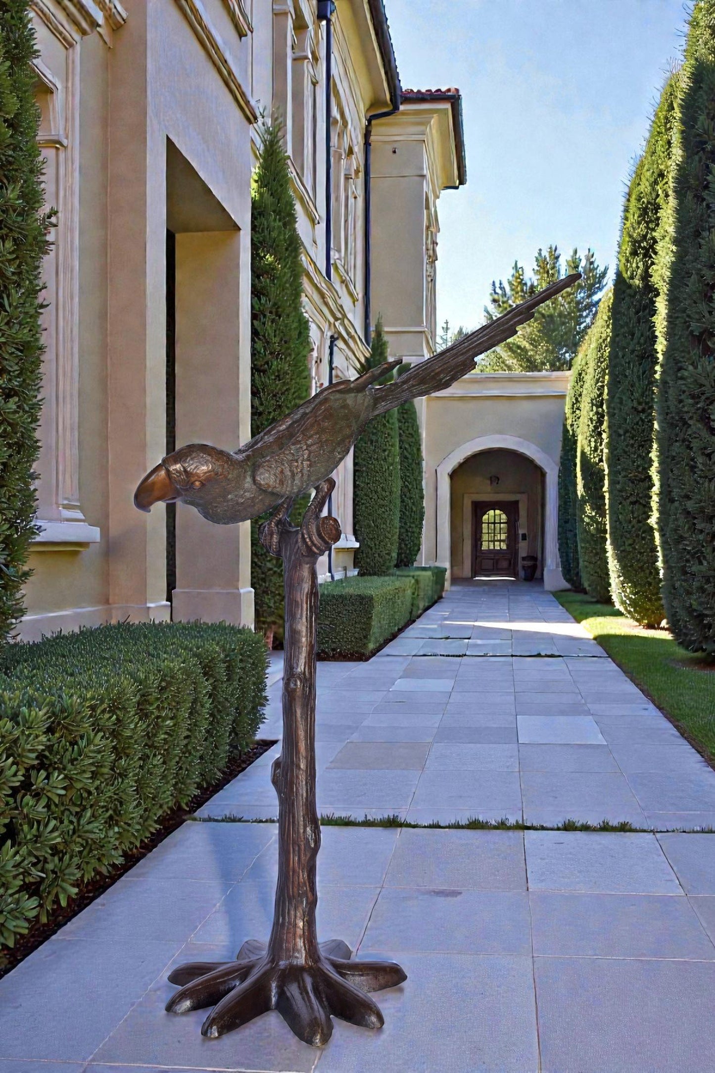 Parrot on a Tree looking Down Bronze Statue - Size: 37"L x 15"W x 47"H.