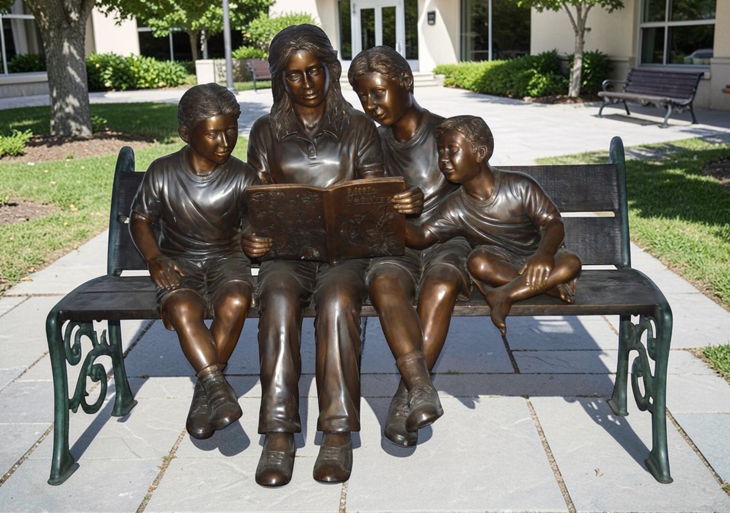 Mom and boys reading stories on bench bronze statue - Size: 53"L x 33"W x 39"H.