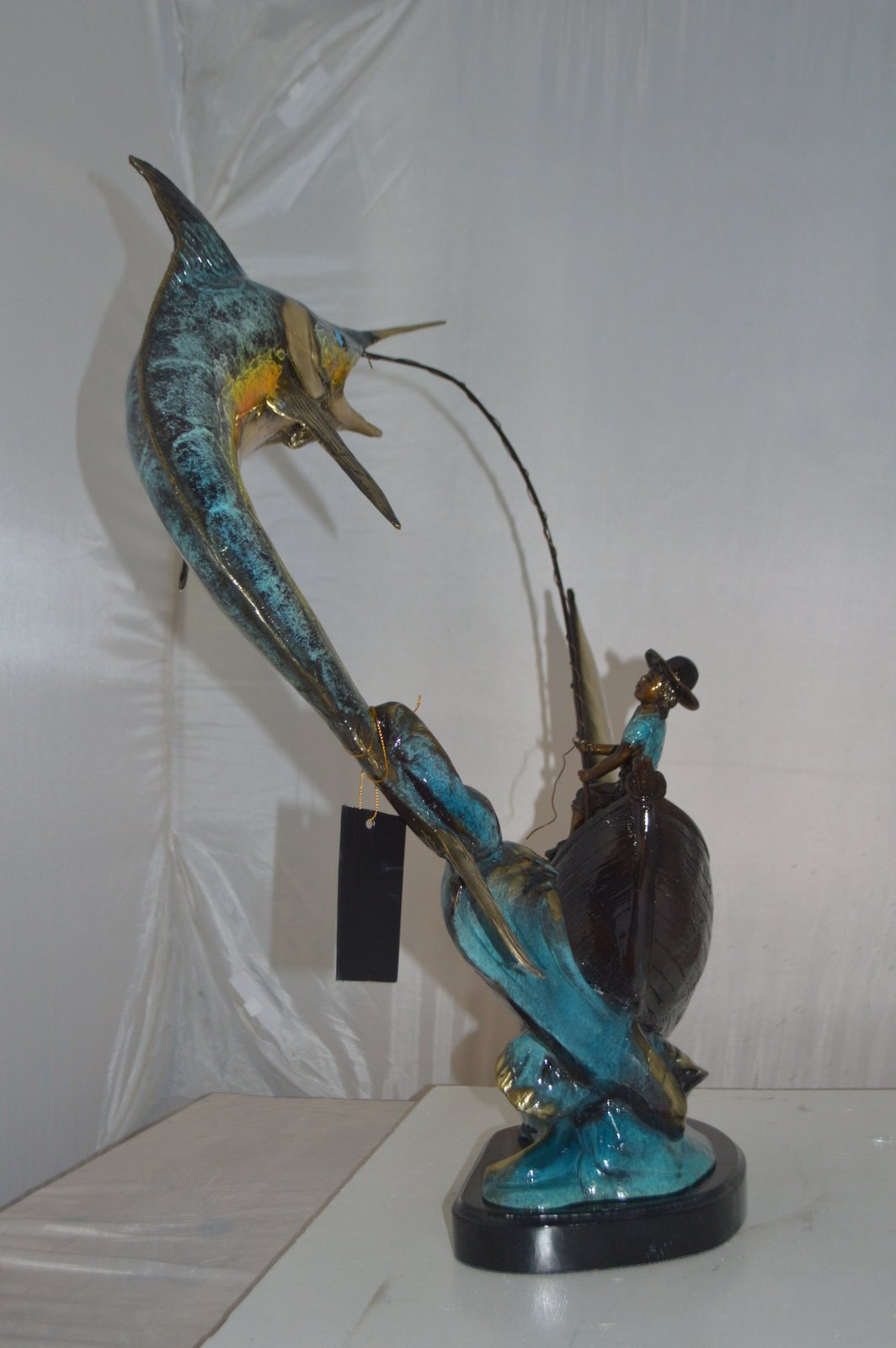 Old Man Fishing a Large Catch Bronze Statue -  Size: 27"L x 13"W x 30"H.