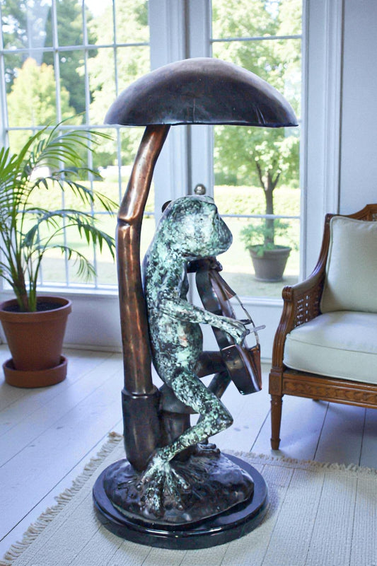 Frog playing cello under mushroom bronze statue -  Size: 10"L x 10"W x 24"H.