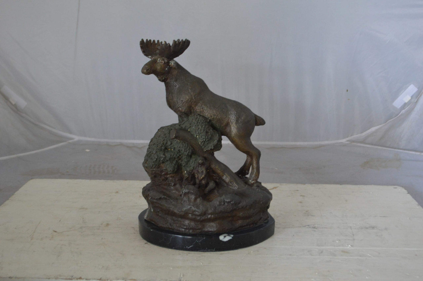Moose on a rock bronze statue - Size: 9"L x 7"W x 14"H.