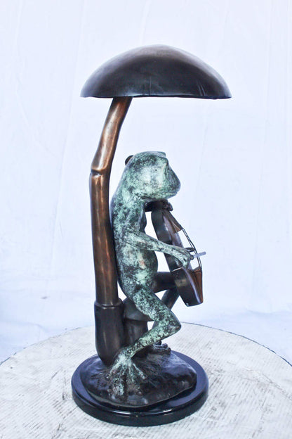 Frog playing cello under mushroom bronze statue -  Size: 10"L x 10"W x 24"H.