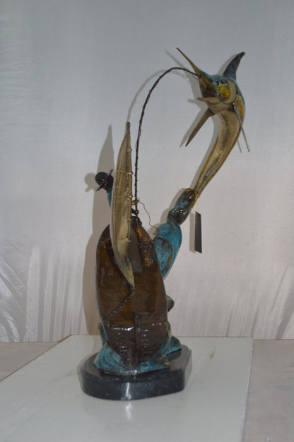 Old Man Fishing a Large Catch Bronze Statue -  Size: 27"L x 13"W x 30"H.
