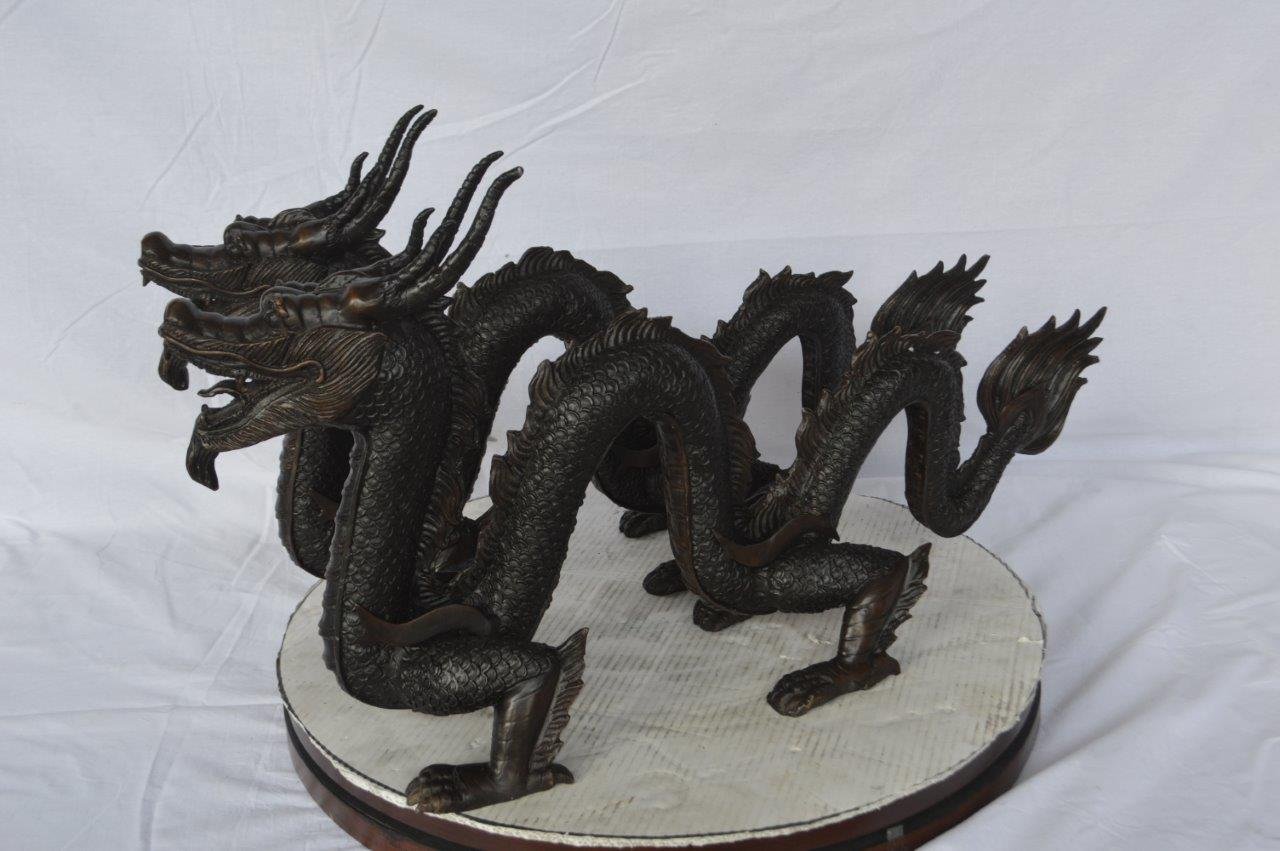 Pair of Dragons sitting side by side bronze statues -  Size: 31"L x 7"W x 16"H.