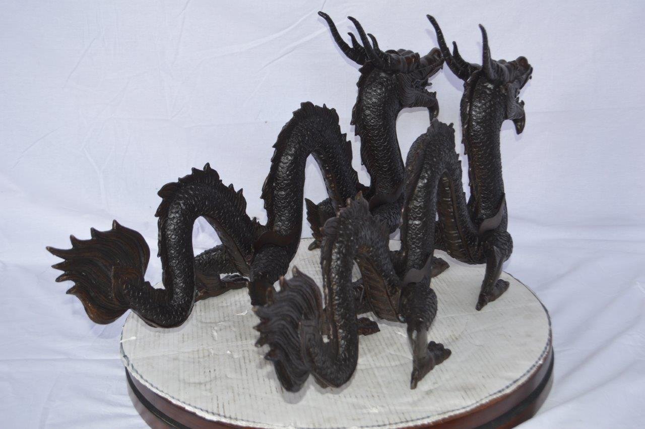 Pair of Dragons sitting side by side bronze statues -  Size: 31"L x 7"W x 16"H.