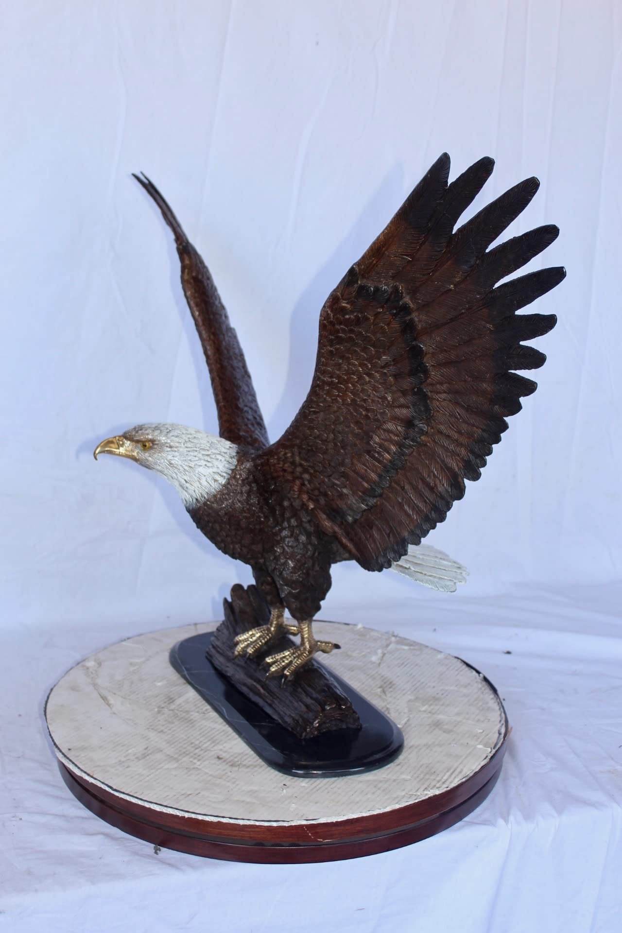 Perched eagle bronze statue -  Size: 35"L x 21"W x 29"H.